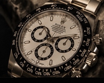 Rolex Daytona watch photographed in dramatic warm lighting